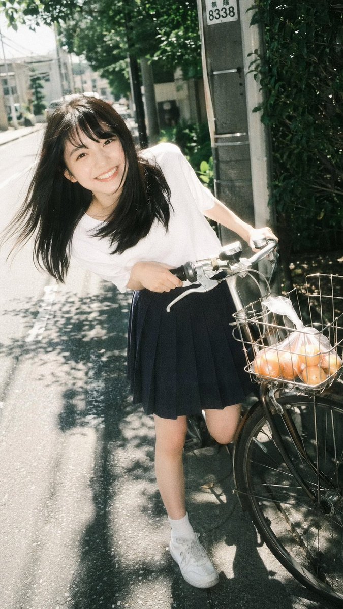 Vintage Film Portrait of Girl with Bicycle のQwen Imageプロンプト例: Generates a photorealistic, nostalgic portrait of a young woman posing with a bicycle on a sunny street.