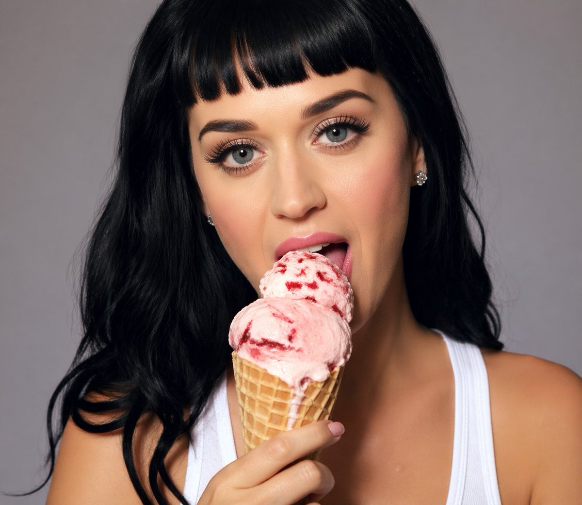 Studio Portrait With Strawberry Ice Cream GPT Image 2 prompt example: This prompt generates a sleek celebrity-style studio portrait of a dark-haired woman holding a strawberry...