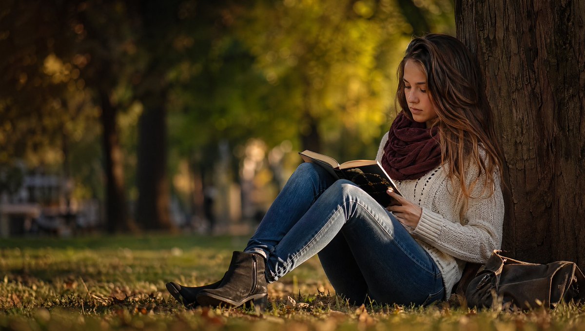 Autumn Park Reading Stock Photo Qwen Image prompt example: This prompt generates a warm, realistic stock-style image of a person reading by a tree in an autumn park, ideal for...