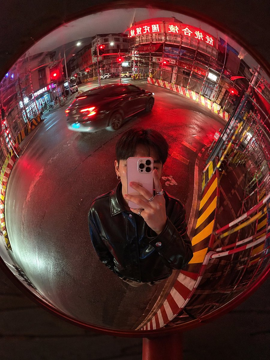 Convex Mirror Night Street Selfie Qwen Image prompt example: This prompt generates a cinematic realistic fisheye selfie in a roadside convex mirror, ideal for urban night...