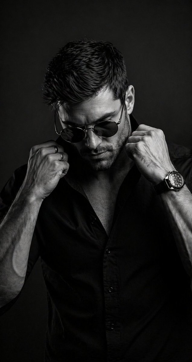 B&W Cinematic Studio Portrait Qwen Image prompt example: A prompt for a dramatic, high-contrast black and white portrait of a man in round sunglasses.