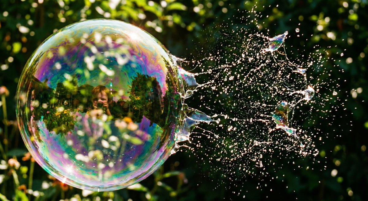 Bursting Soap Bubble Macro Photo 的 GPT Image 2 提示词示例图 变化图 2：This prompt generates a photorealistic high-speed macro image of a child blowing a soap bubble as it bursts into...