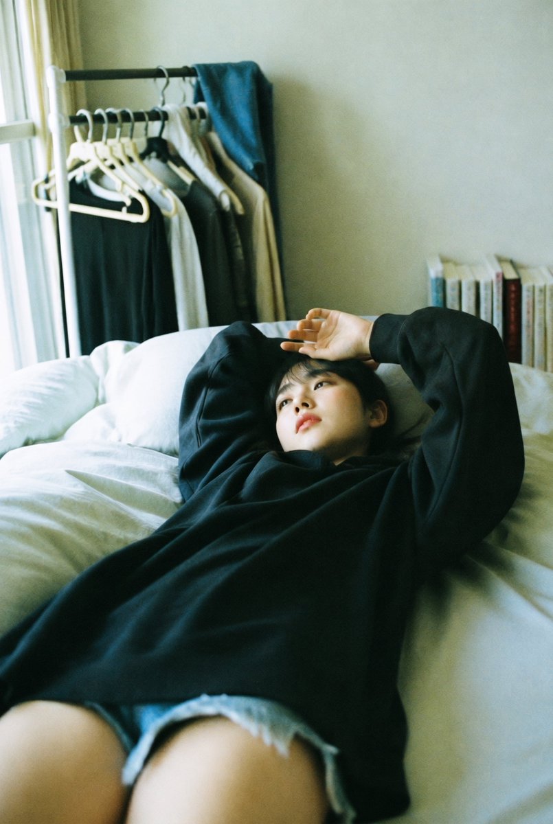 Candid Bedroom Lounge Photo GPT Image 2 prompt example: This prompt generates a soft, realistic vertical lifestyle photo of a woman resting on a bed in a minimalist room, ideal...