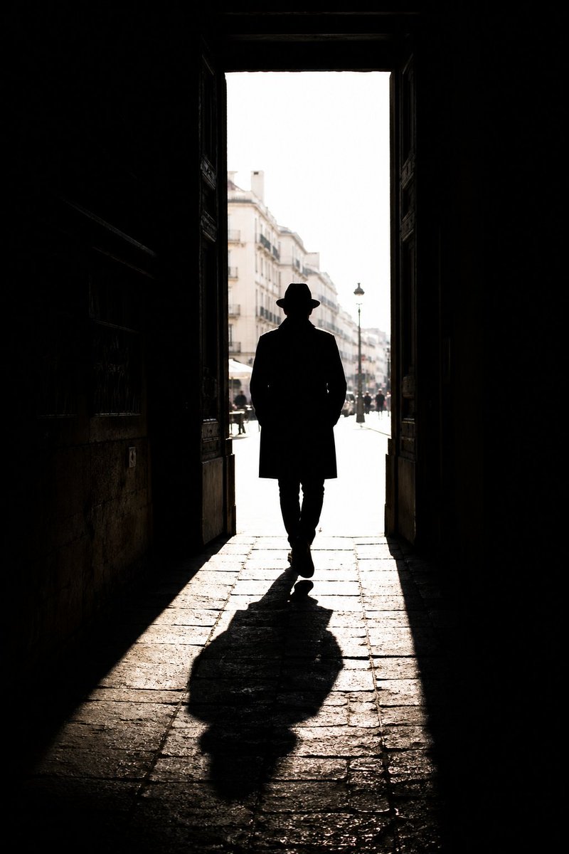 High Contrast Urban Silhouette 的 GPT Image 2 提示词示例图:A prompt for street photography focusing on silhouettes, strong directional sunlight, and cinematic urban composition.