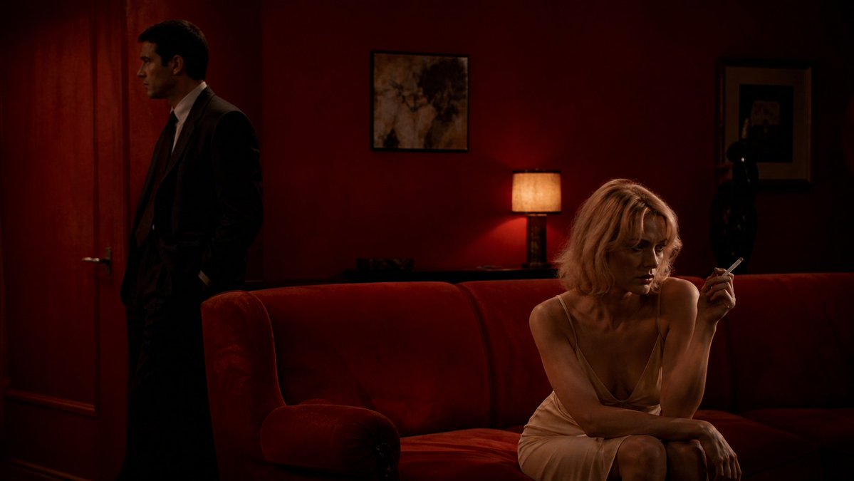 Crimson Noir Lounge Scene Qwen Image prompt example: A cinematic prompt for generating a tense, low-lit neo-noir lounge scene with two anonymized figures in a red velvet interior.